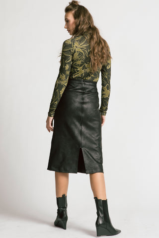 Back view of model wearing olive floral turtleneck and black faux leatherette Graduate skirt by Allison Wonderland. 