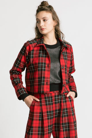 Woman wearing red plaid pants with matching red plaid button up Maurice Jacket by Allison Wonderland. 