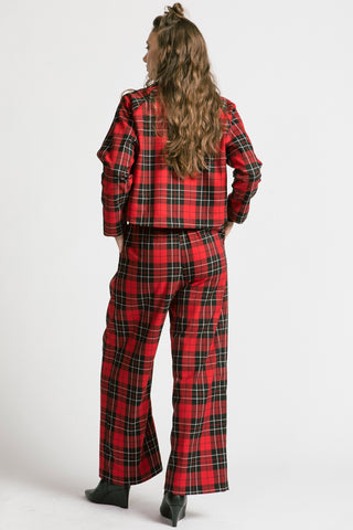 Back view of woman wearing red plaid pants with matching red plaid button up Maurice Jacket by Allison Wonderland. 