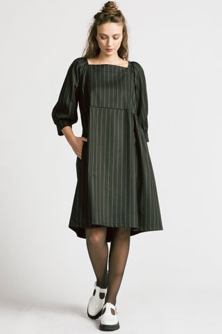 Woman wearing black and white pinstripe relaxed babydoll Notebook dress by Allison Wonderland. 