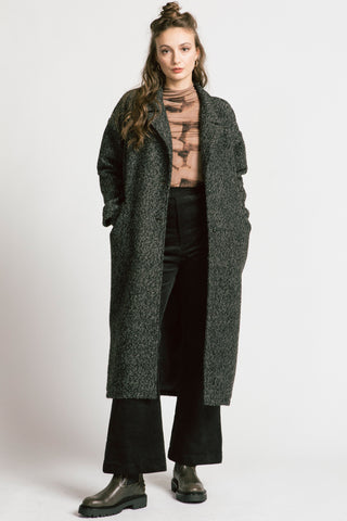 Woman wearing grey bouclé oversized coat by Allison Wonderland. 