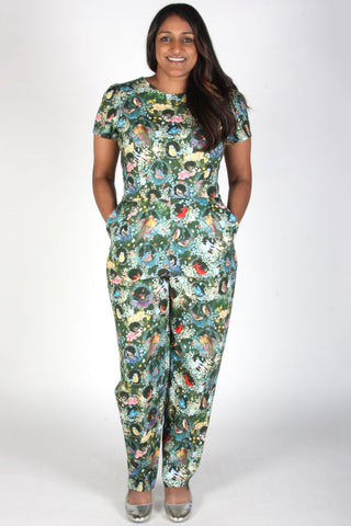 Model wearing bird print short sleeve fitted Auk jumpsuit by Birds of North America. 