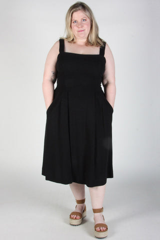 Woman wearing black fit and flare Thornbill dress by Birds of North America. 