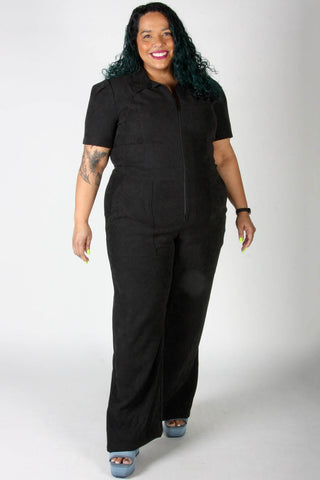 Model wearing black zip up Tyrannulet jumpsuit by Birds of North America. 