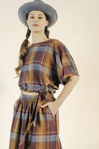 Model wearing plaid puff sleeve Charles top by Bodybag. 