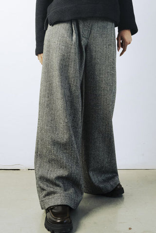 Model wearing wide leg wool blend herringbone Lewis pants by Bodybag. 