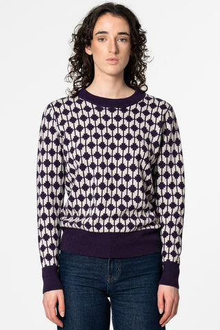 Woman wearing purple merino wool Dhaka sweater by Dinadi. 