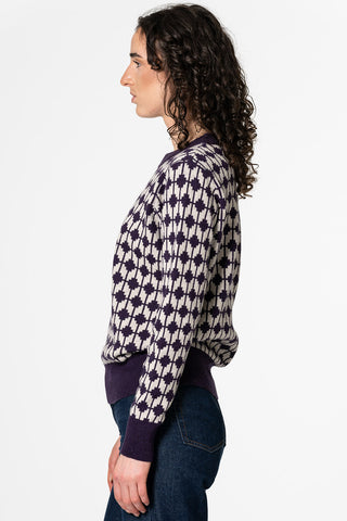 Side view of woman wearing purple merino wool Dhaka sweater by Dinadi. 