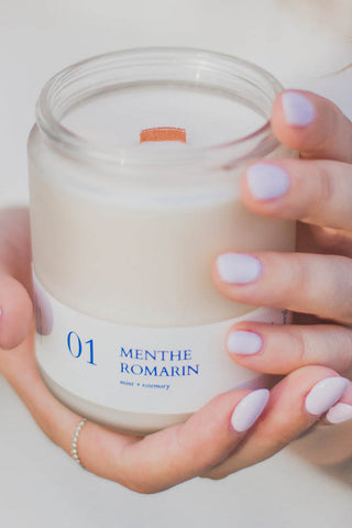 Woman's hands holding Flambette Mint & Rosemary soy wax candle. 