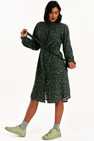 Woman wearing green floral print Ceremony shirt dress by Jennifer Glasgow. 