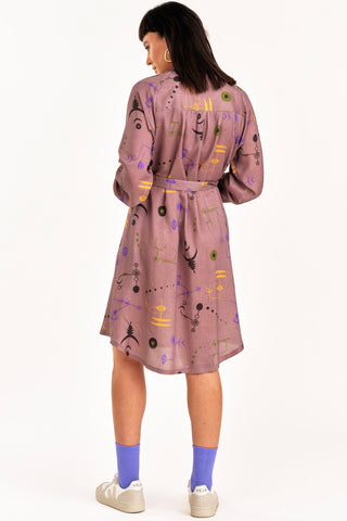 Back view of woman wearing mauve Crop Circle print Ceremony shirt dress by Jennifer Glasgow. 