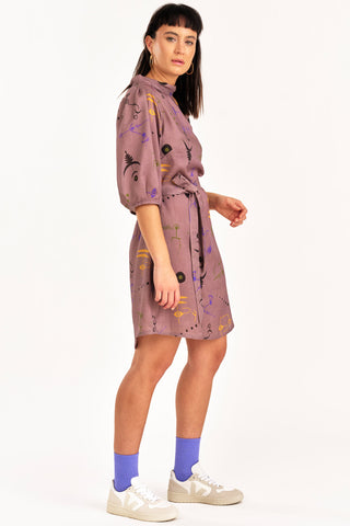 Side view of woman wearing purple crop circle print button up Enduring Dress by Jennifer Glasgow. 