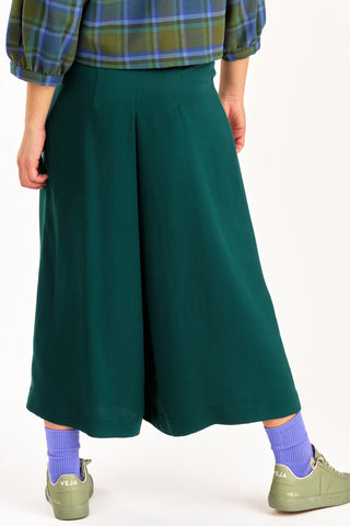 Back view of cropped green wide leg Harlow pants by Jennifer Glasgow. 