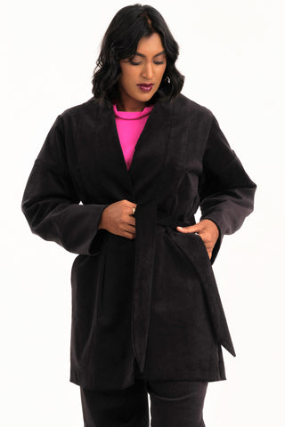 Woman wearing black fine corduroy Orlop jacket by Jennifer Glasgow. 