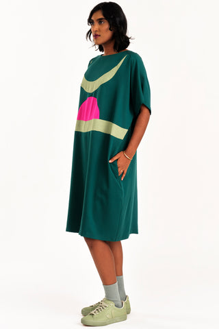 Woman wearing green and fuchsia colour blocked Rise tunic by Jennifer Glasgow. 