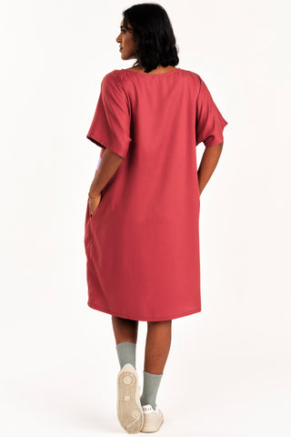 Back view of oman wearing dark pink and lilac colour blocked Rise tunic by Jennifer Glasgow. 