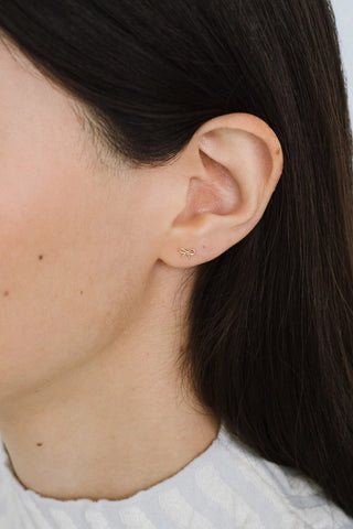 Woman wearing 14k Gold plated Kara Yoo Harper stud earrings.