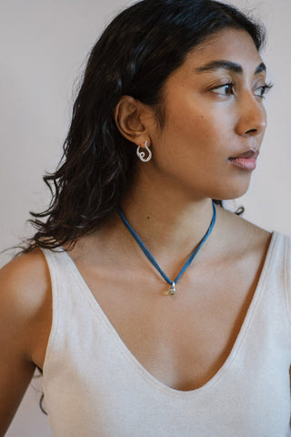 Woman wearing sterling silver Kara Yoo Loop studs. 