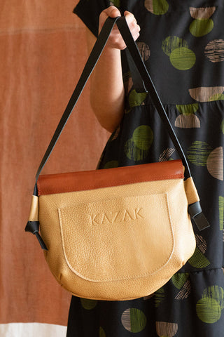 Close-up of camel and rust recycled leather Mahwa bag by Kazak. 