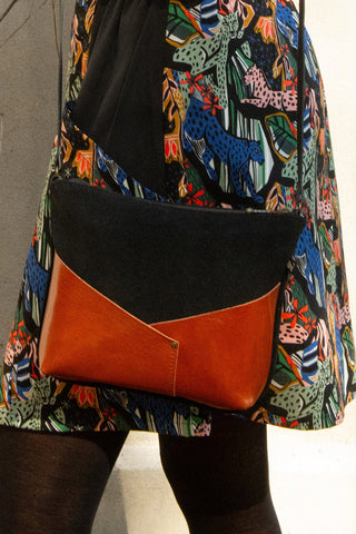 Close-up of black suede and fox recycled leather Woodstock bag by Kazak. 