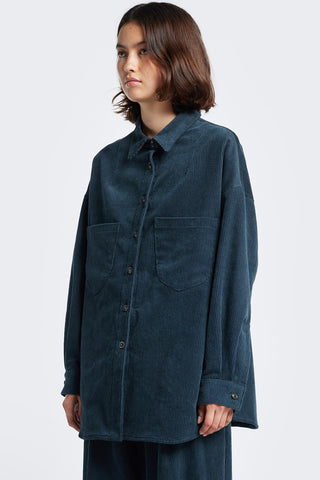 Model wearing petrol blue oversized corduroy Proclaim shirt by Kloke. 