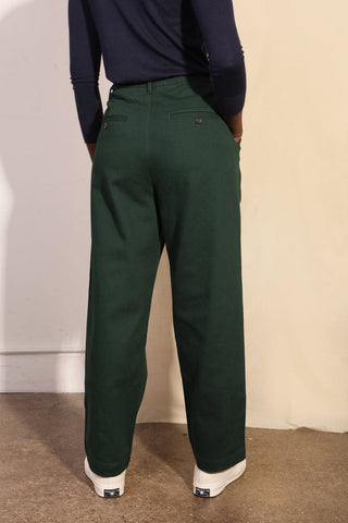 Back view of model wearing forest green relaxed fit Classic Slacks by LF Markey. 