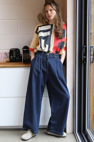 Model in kitchen wearing wide leg pleated Myles jeans by LF Markey. 