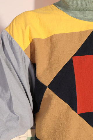 Close-up of Woman wearing colourful colour blocked Sloane Top by LF Markey. 