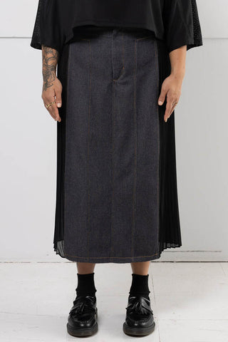 Model wearing black denim Harmony skirt with pleated chiffon side panels by Mercy House. 