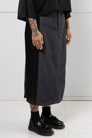 Model wearing black denim Harmony skirt with pleated chiffon side panels by Mercy House. 