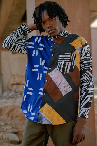 Model wearing oversized multicolour button up batik print Bula shirt by Osei Duro. 