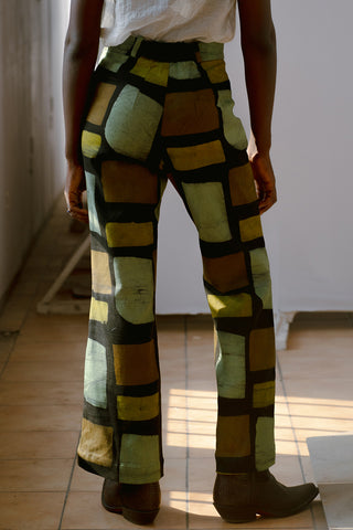 Back view of model wearing Veronica pants in pistachio print by Osei Duro. 