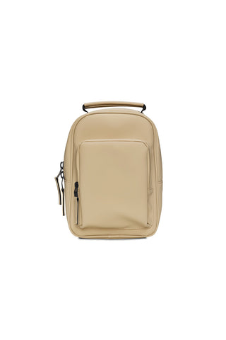 Front view of sand coloured RAINS Book Daypack mini one strap backpack. 