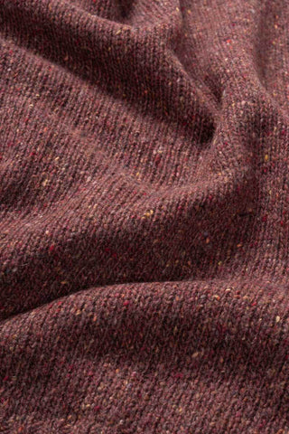 Closeup of orange flecked recycled cashmere of the Eloisa sweater by Rifo. 