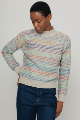 Model wearing recycled wool rainbow coloured Morgana Sweater by Rifo. 