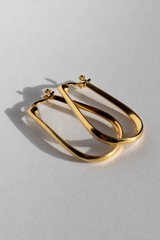 Gold Lyn hopp earrings by Sarah Mulder. 