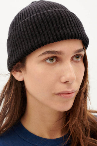 Model wearing black wool Amor beanie  by Thinking Mu. 