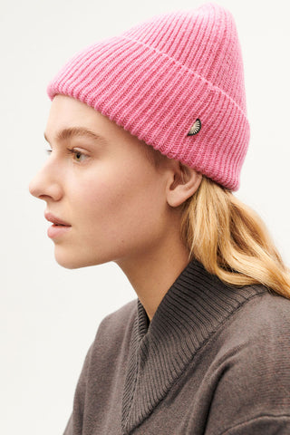 Model wearing pink wool Amor Beanie by Thinking Mu. 