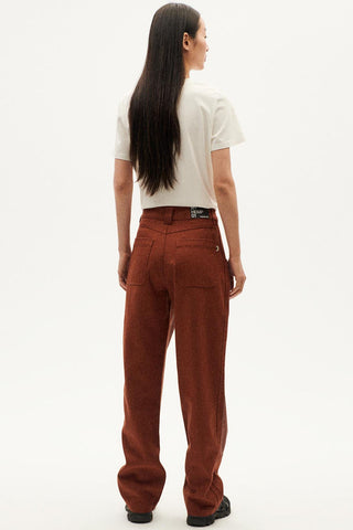 Back view of model wearing brown hemp & organic cotton Perle pants by Thinking Mu. 