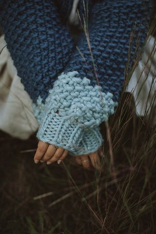 Woman wearing blue chunky knit merino wool Cutie Sweater by Toast & Yarn. 