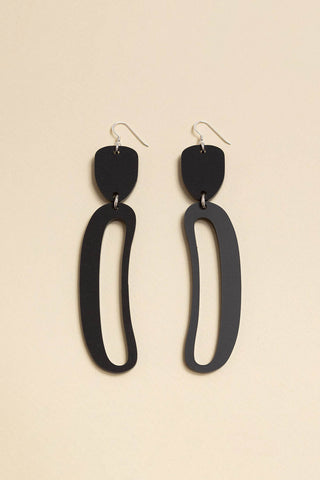 Matte black Elongated Ovoid acrylic earrings by Warren Steven Scott. 