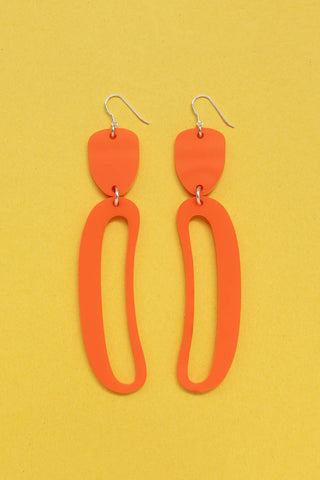 Opaque orange Elongated Ovoid acrylic earrings by Warren Steven Scott. 