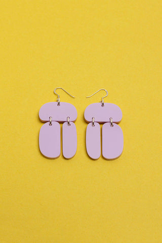 Opaque lilac Ovoid Trio acrylic earrings by Warren Steven Scott. 